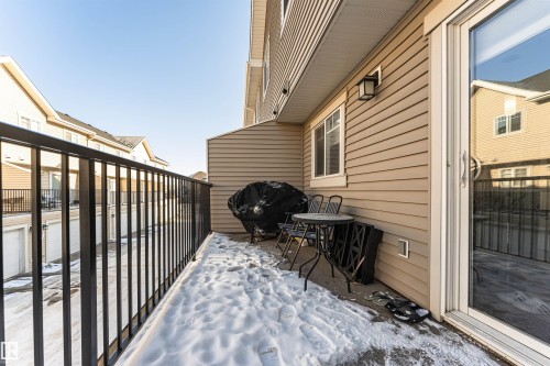 The property features a private balcony with a metal railing, providing outdoor space - 35 675 Albany Way Nw, Edmonton, AB - Outdoor With Exterior