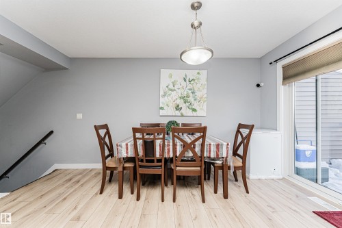 Dining area with light-toned flooring and a sliding glass door providing outdoor access - 35 675 Albany Way Nw, Edmonton, AB - Indoor Photo Showing Dining Room