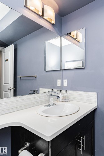 Bathroom vanity with a white countertop and an undermount sink - 35 675 Albany Way Nw, Edmonton, AB - Indoor Photo Showing Bathroom