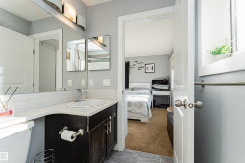 Bathroom featuring a dark wood vanity with a white countertop and an undermount sink - 35 675 Albany Way Nw, Edmonton, AB - Indoor Photo Showing Bathroom