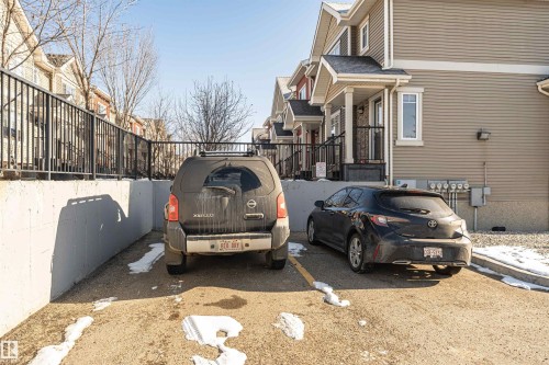The property features dedicated parking spaces and a well-maintained exterior with durable siding - 35 675 Albany Way Nw, Edmonton, AB - Outdoor