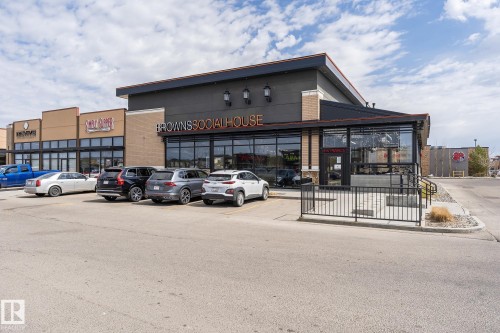 The commercial property features a contemporary facade with large windows and a prominent business sign - 35 675 Albany Way Nw, Edmonton, AB - Outdoor