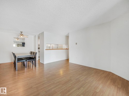 Open-concept living space with wood-finish flooring - 143 10636 120 Street Nw, Edmonton, AB - Indoor