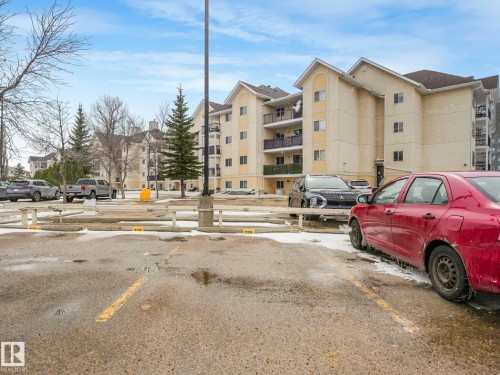 Multi-story stucco building featuring multiple balconies with black railings - 143 10636 120 Street Nw, Edmonton, AB - Outdoor