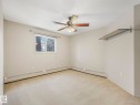 Neutral-toned wall paint complements the light-colored carpeting - 143 10636 120 Street Nw, Edmonton, AB  - Indoor Photo Showing Other Room 