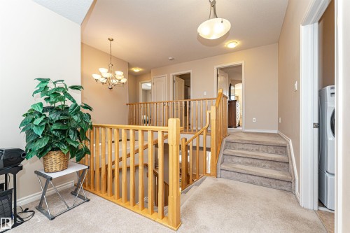Upper landing featuring wood balusters and carpeted flooring - 1915 126 Street, Edmonton, AB - Indoor Photo Showing Other Room