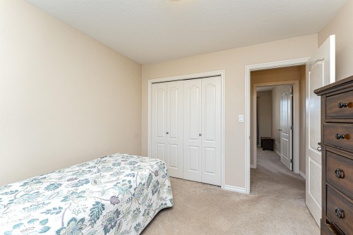 Carpeted room with neutral wall tones and white baseboards - 1915 126 Street, Edmonton, AB - Indoor Photo Showing Bedroom
