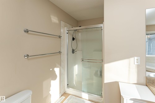 Shower enclosure with a glass door, chrome hardware, and tiled surround - 1915 126 Street, Edmonton, AB - Indoor Photo Showing Bathroom