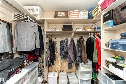 Built-in closet system featuring multiple hanging rods, extensive shelving, and ample storage capacity - 1915 126 Street, Edmonton, AB - Indoor With Storage