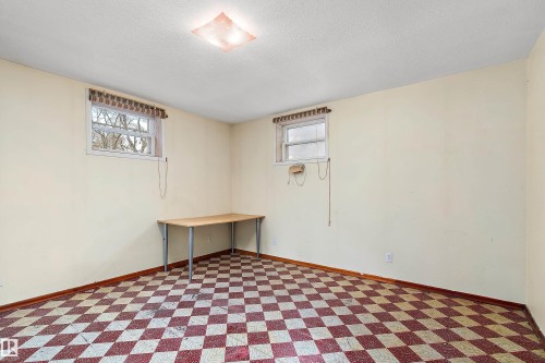 Room featuring checkerboard flooring, two windows with valances, and a ceiling-mounted light fixture - 10124 88 Avenue, Edmonton, AB - Indoor Photo Showing Bedroom