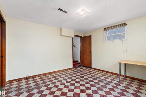 Room featuring a red and white checkered floor, painted walls, and a window with blinds - 10124 88 Avenue, Edmonton, AB - Indoor Photo Showing Bedroom