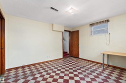 Room featuring a red and white checkered floor, painted walls, and a window with blinds - 