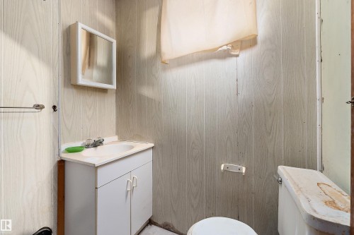 Bathroom featuring wood-finish wall paneling - 10124 88 Avenue, Edmonton, AB - Indoor Photo Showing Bathroom
