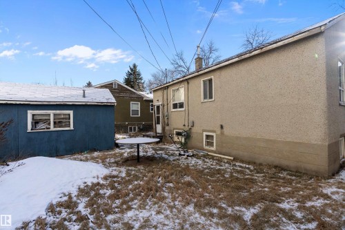 Stucco exterior with multiple windows and a visible chimney - 10124 88 Avenue, Edmonton, AB - Outdoor