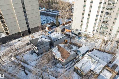 Aerial perspective showcasing multiple residential structures with pitched roofs and surrounding grounds - 10124 88 Avenue, Edmonton, AB - Outdoor