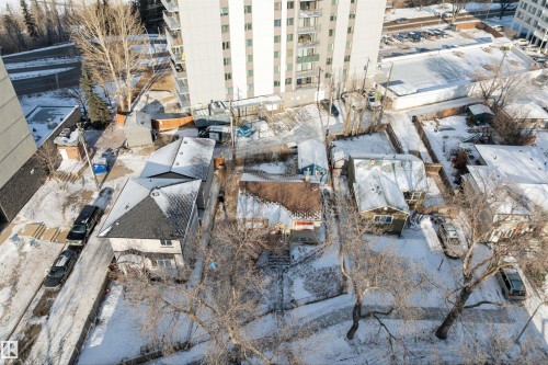 Urban residential properties featuring pitched roofs and established trees - 10124 88 Avenue, Edmonton, AB - Outdoor