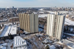 High-rise apartment buildings featuring balconies and a surrounding urban landscape - 