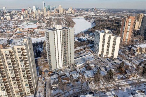 High-rise residential building featuring multiple balconies, a flat roof, and an adjacent parking area - 10124 88 Avenue, Edmonton, AB - Outdoor With View