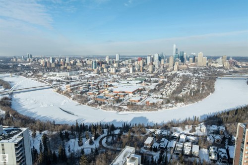 Expansive aerial perspective showcasing a metropolitan skyline, a winding frozen river, and a snow-covered landscape - 10124 88 Avenue, Edmonton, AB - Outdoor With View