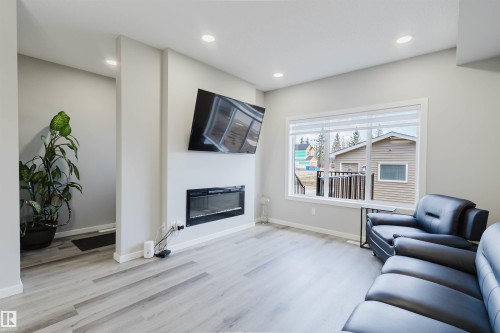 Living area featuring light gray walls, recessed lighting, and wood-finish flooring - 343 Edgemont Drive, Edmonton, AB - Indoor Photo Showing Living Room With Fireplace