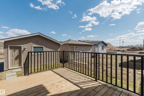Exterior wood deck with black metal railing - 343 Edgemont Drive, Edmonton, AB - Outdoor With Deck Patio Veranda