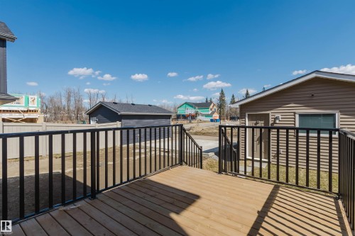 Wood-finish deck with black metal railings - 343 Edgemont Drive, Edmonton, AB - Outdoor With Deck Patio Veranda With Exterior