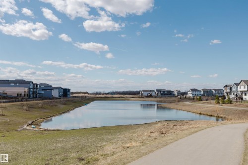 Expansive pond with surrounding green space, bordered by a paved pathway and residential properties - 343 Edgemont Drive, Edmonton, AB - Outdoor With View