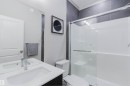 Contemporary bathroom featuring a vanity with an integrated sink, polished chrome faucet, and a large wall mirror - 343 Edgemont Drive, Edmonton, AB  - Indoor Photo Showing Bathroom 