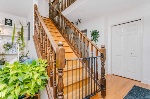 Hardwood staircase with turned balusters and a dark wood handrail - 17820 57 Avenue, Edmonton, AB - Indoor Photo Showing Other Room