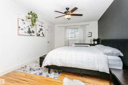 Bedroom featuring wood-finish flooring and a ceiling fan with integrated lighting - 17820 57 Avenue, Edmonton, AB - Indoor Photo Showing Bedroom