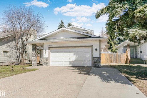 Modern facade with horizontal siding, stone accent columns, and a double garage - 17820 57 Avenue, Edmonton, AB - Outdoor