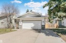 Modern facade with horizontal siding, stone accent columns, and a double garage - 17820 57 Avenue, Edmonton, AB  - Outdoor 