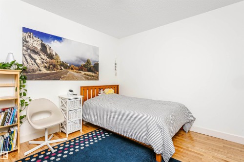 White walls with wood-finish flooring - 17820 57 Avenue, Edmonton, AB - Indoor Photo Showing Bedroom