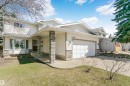 Two-story residence featuring white siding and a covered entry with stone-clad pillars - 17820 57 Avenue, Edmonton, AB  - Outdoor 