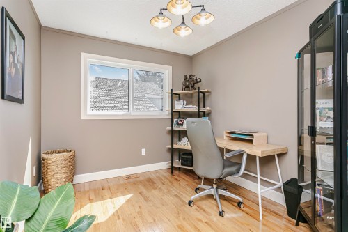 Room featuring light wood-finish flooring, neutral wall paint, and white baseboards - 17820 57 Avenue, Edmonton, AB - Indoor Photo Showing Office