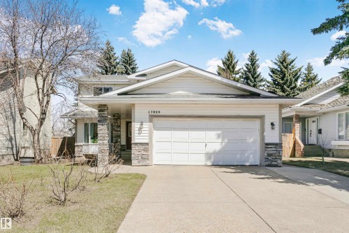 Contemporary two-story residence featuring a two-car garage, stone veneer accents, and a concrete driveway - 17820 57 Avenue, Edmonton, AB - Outdoor With Facade