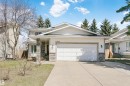 Contemporary two-story residence featuring a two-car garage, stone veneer accents, and a concrete driveway - 17820 57 Avenue, Edmonton, AB  - Outdoor With Facade 