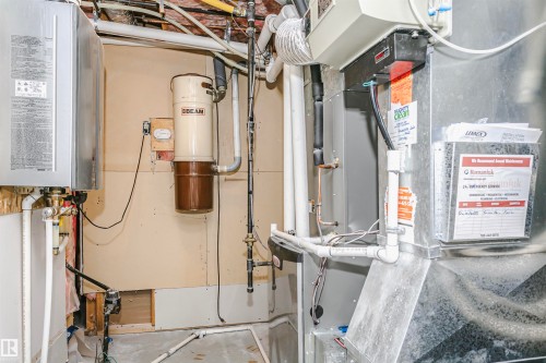 HVAC system, water heater, and central vacuum unit - 17820 57 Avenue, Edmonton, AB - Indoor Photo Showing Basement
