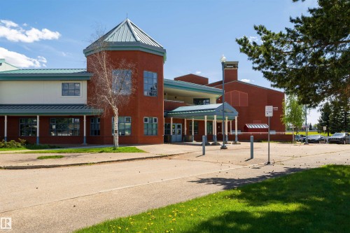 Red brick building with a prominent octagonal tower and a conical roof - 17820 57 Avenue, Edmonton, AB - Outdoor