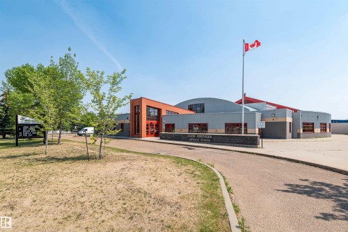Contemporary institutional building featuring a combination of brick and paneling exterior - 17820 57 Avenue, Edmonton, AB - Outdoor With Deck Patio Veranda