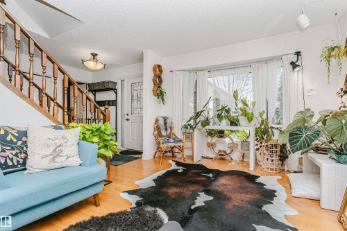 Hardwood-style flooring throughout the main living area - 17820 57 Avenue, Edmonton, AB - Indoor