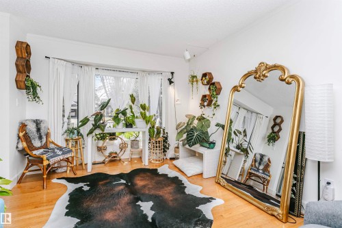 Hardwood flooring and white walls complement a bay window with a multi-pane design - 17820 57 Avenue, Edmonton, AB - Indoor