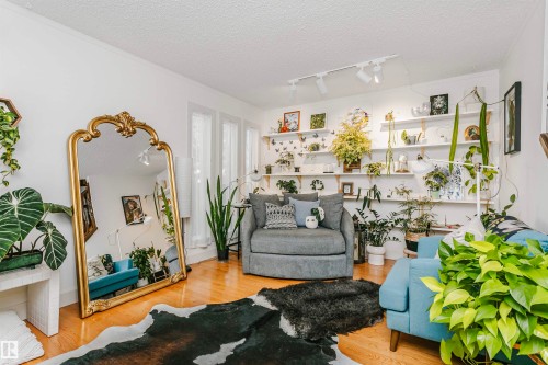 Living space with hardwood flooring and white walls - 17820 57 Avenue, Edmonton, AB - Indoor Photo Showing Living Room