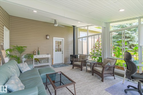 Screened porch featuring light-toned siding, a white paneled ceiling, recessed lighting, and a ceiling fan - 10339 36A Avenue, Edmonton, AB - Outdoor With Deck Patio Veranda With Exterior