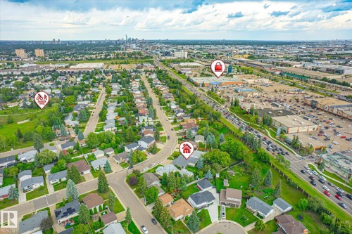 Aerial perspective showcasing a residential neighborhood with mature trees and a distant city skyline - 10339 36A Avenue, Edmonton, AB - Outdoor With View