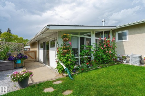 Sunroom addition with multiple windows, leading to a concrete patio area - 10339 36A Avenue, Edmonton, AB - Outdoor With Exterior
