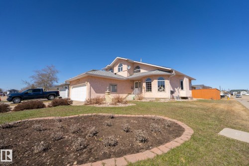 Stucco exterior with a two-car garage and 2 outdoor parking spaces - 5736 161 Avenue, Edmonton, AB - Outdoor
