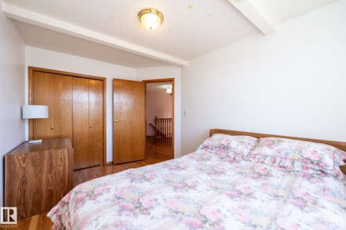 Hardwood flooring throughout, featuring a bi-fold closet and solid wood doors - 5736 161 Avenue, Edmonton, AB - Indoor Photo Showing Bedroom