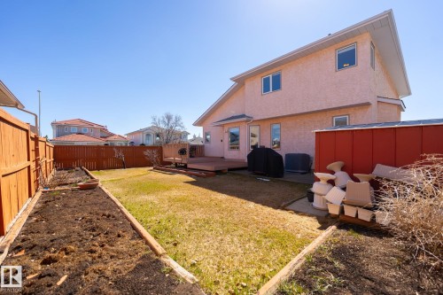 Spacious backyard featuring a raised garden bed, full wood privacy fencing, and a multi-level wooden deck - 5736 161 Avenue, Edmonton, AB - Outdoor With Exterior