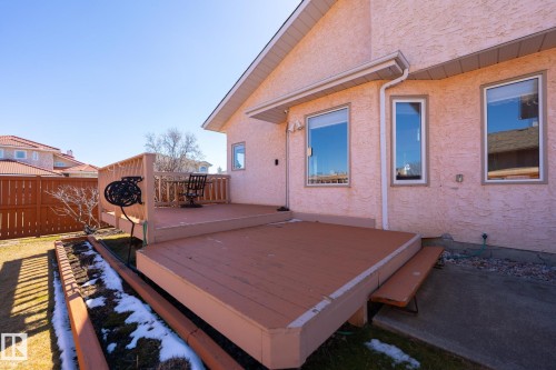 Multi-level wood deck with privacy screen, stucco exterior, and white-framed windows - 5736 161 Avenue, Edmonton, AB - Outdoor With Exterior